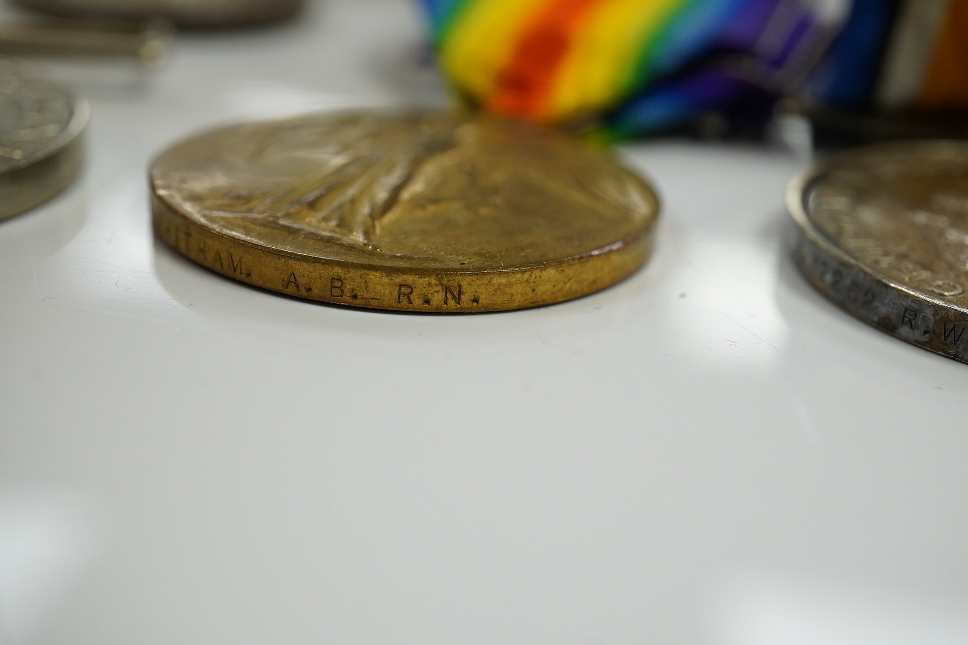 A WWI and WWII medal group awarded to R. Whitham A.B. R.N.; a First World War medal trio with a George V Long Service and Good Conduct Medal, together with a 1939-1945 Medal, the Atlantic Star, and the 1939-1945 Star. Co